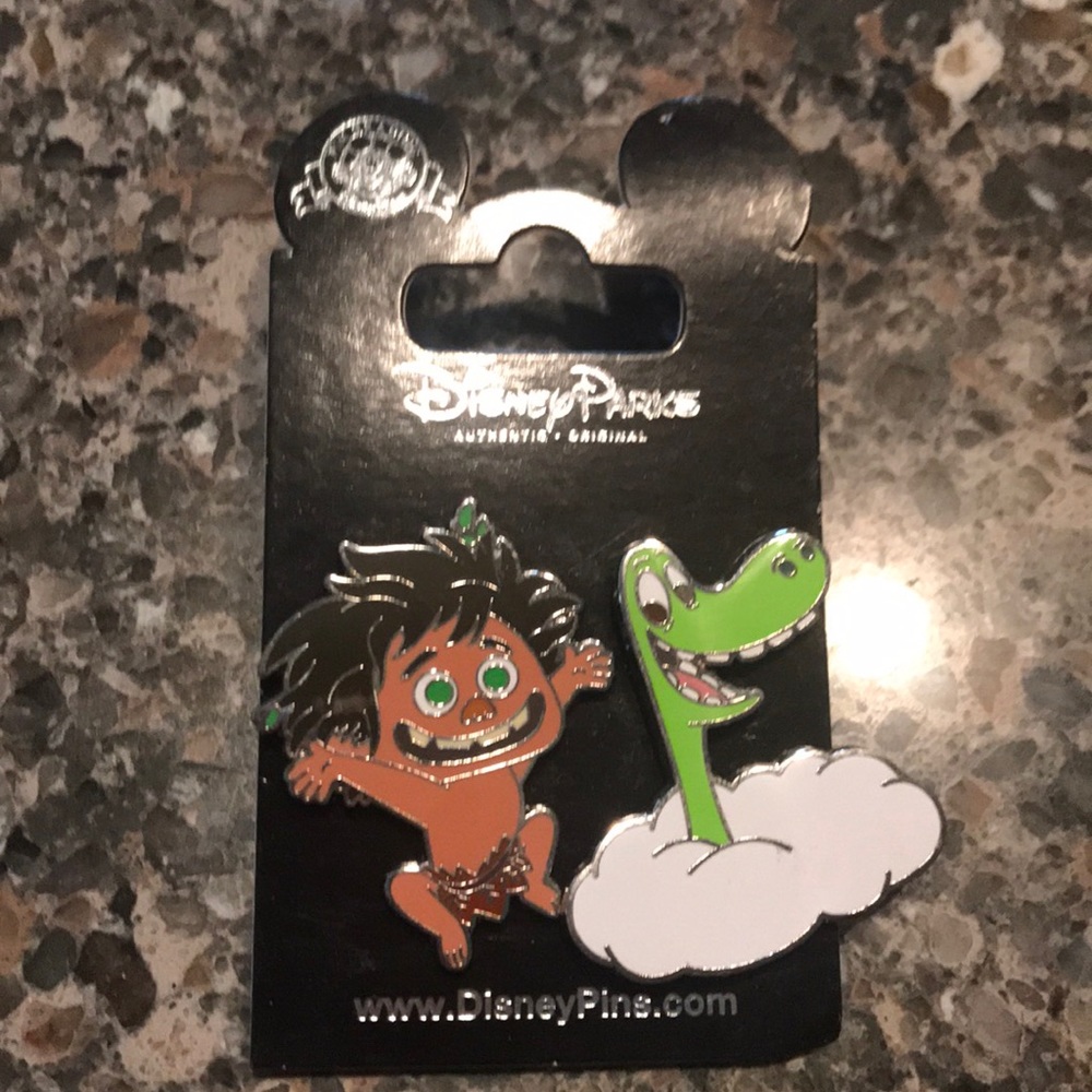 Two Disney Park pins from the movie dinosaur.